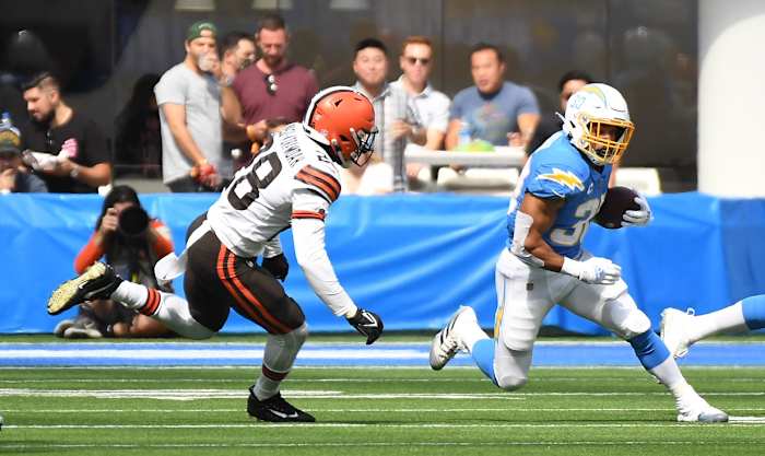 Oct 10, 2021; Inglewood, California, USA; Los Angeles Chargers running back Austin Ekeler (30) runs the ball against Cleveland Browns outside linebacker Jeremiah Owusu-Koramoah (28) in the first half at SoFi Stadium. Mandatory Credit: Richard Mackson-USA TODAY Sports